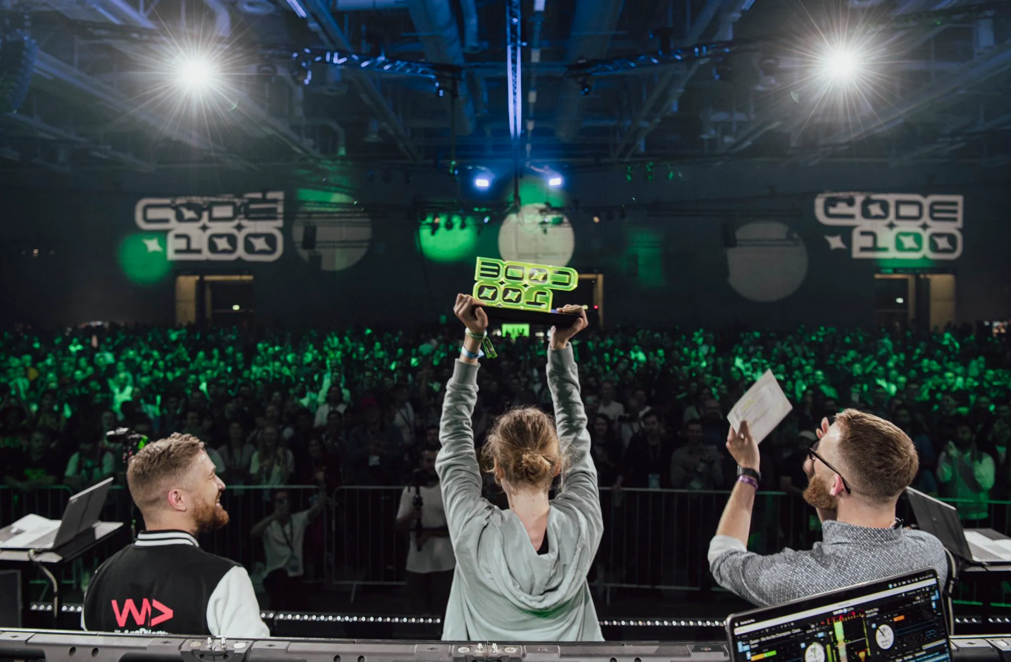 Photo of Felix holding the winner's trophy at CODE100